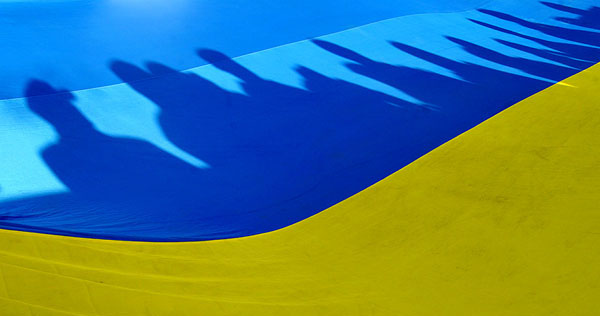 Shadows of people are thrown on a huge U